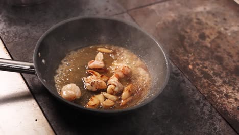 cooking shrimp and garlic in a pan