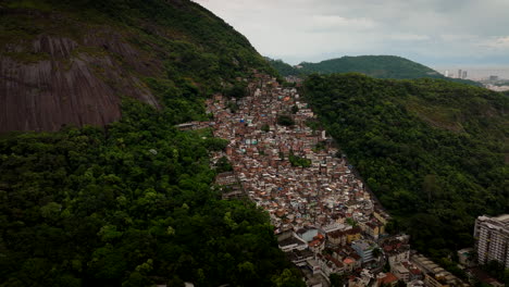 congested built-up favela neighborhood in rio de janeiro, aerial pullback view
