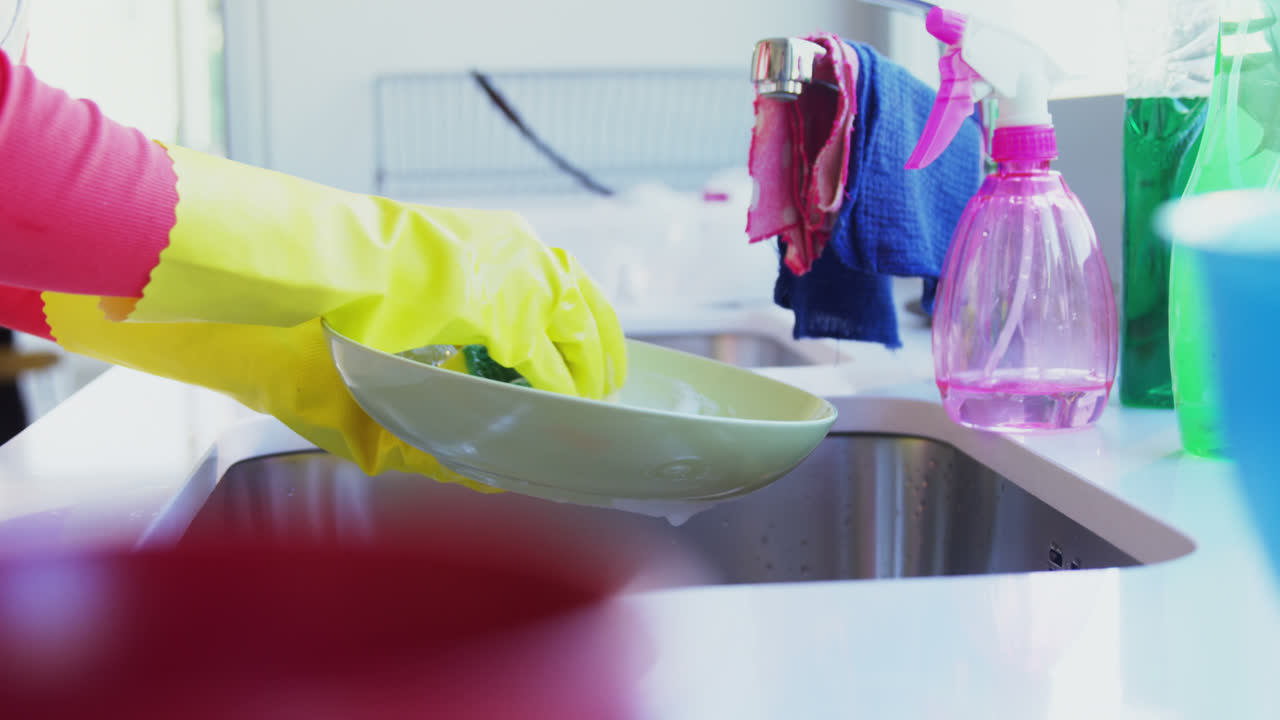 Woman washing utensil in kitchen sink 4k