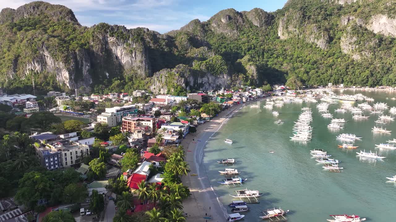 Tropical paradise of El Nido, Palawan. With majestic cliff and sandy beach. Bay with the boats.
