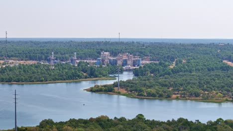 Moving-to-the-left-near-the-top-of-some-heavy-duty-power-lines-that-go-over-a-lake-to-a-power-plant-on-the-other-side-of-the-lake-which-has-an-inlet