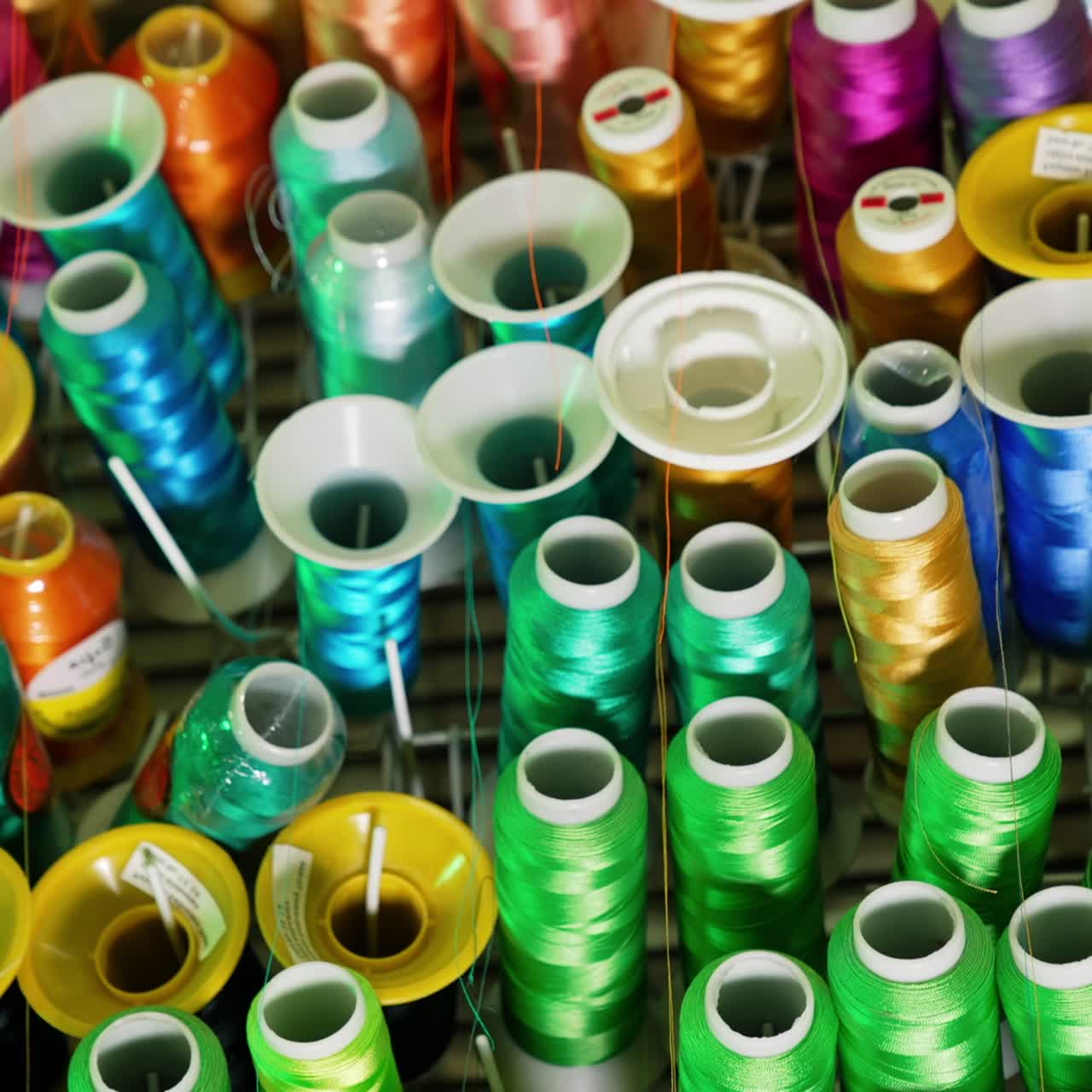 Collection of colorful threads. Different colors of threads in spools. Background of sewing threads. Handicraft concept