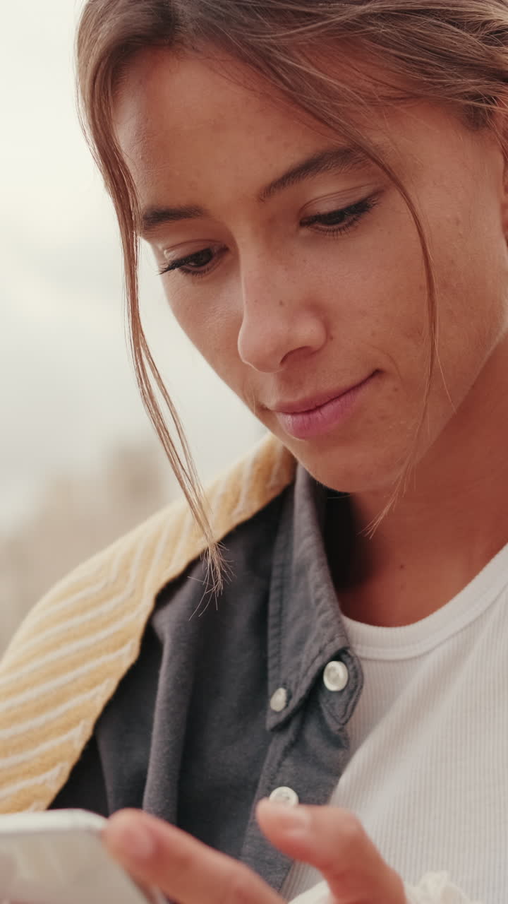 Primo piano di una giovane donna che usa lo smartphone all'aperto