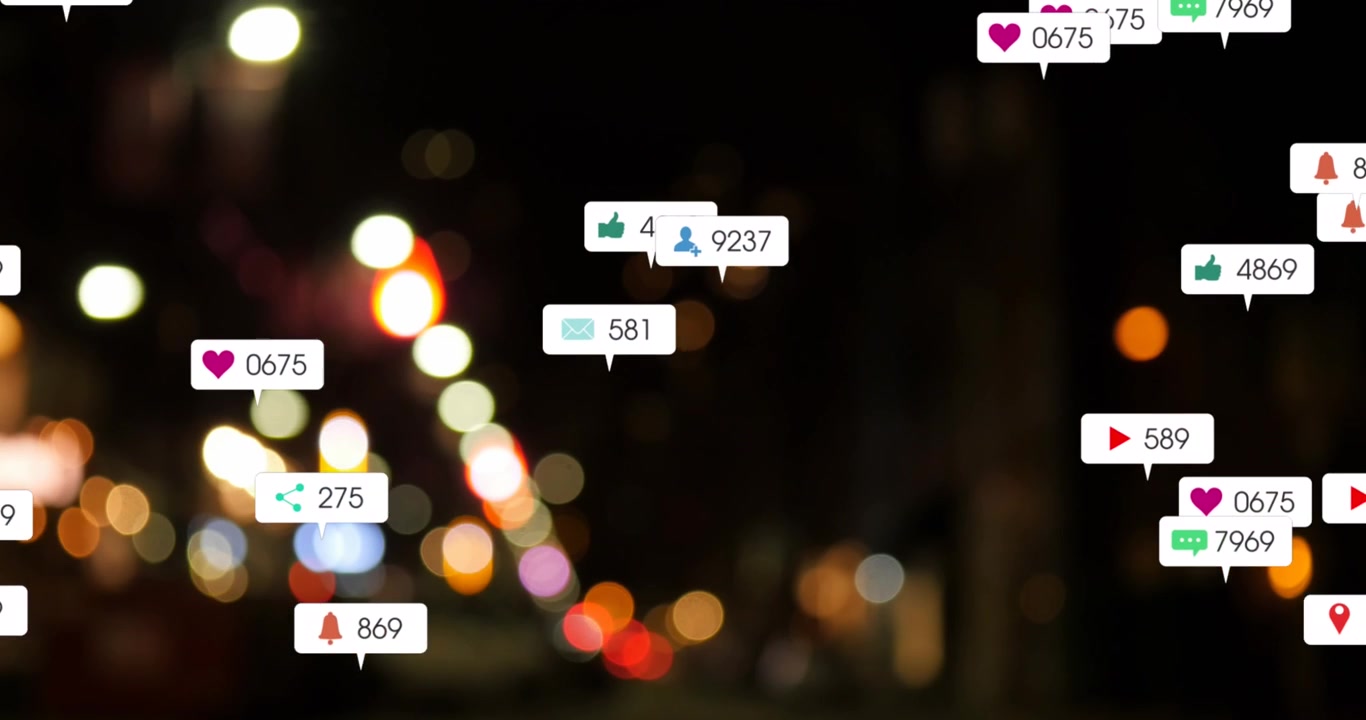 Animation of social media icons and numbers over out of focus city lights
