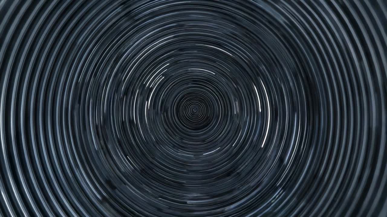 Upon frame two appearing metallic rings rotating in abstract space, creating spiral motion effect