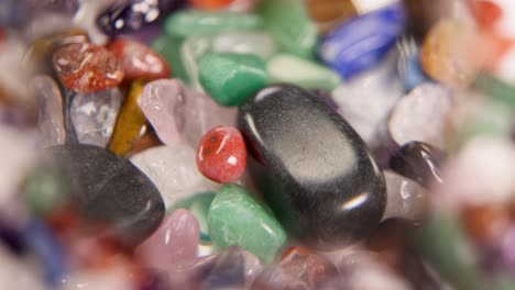 a close-up view of vibrant chakra stones magnified, highlighting their colors and textures in a 13-second video