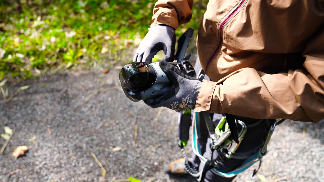 Person unfold drone propeller legs in sunny outdoor environment, Czechia