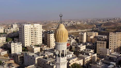 mosque tower minaret in anata refugee camp,on blue sky jerusalem-aerial