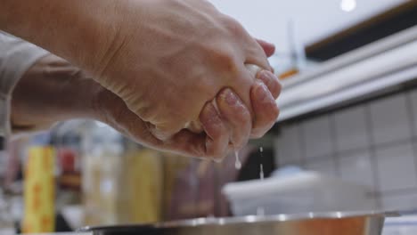 squeezing water from mozzarella cheese