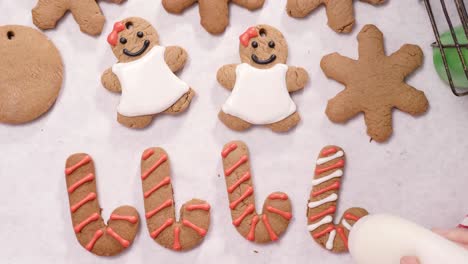 decorating gingerbread cookies with royal icing for christmas.