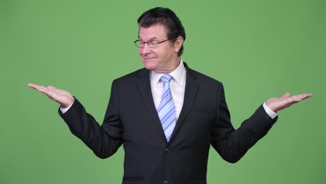senior handsome businessman choosing between left and right