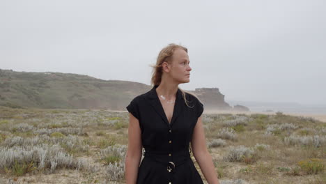 woman in black dress on a foggy beach