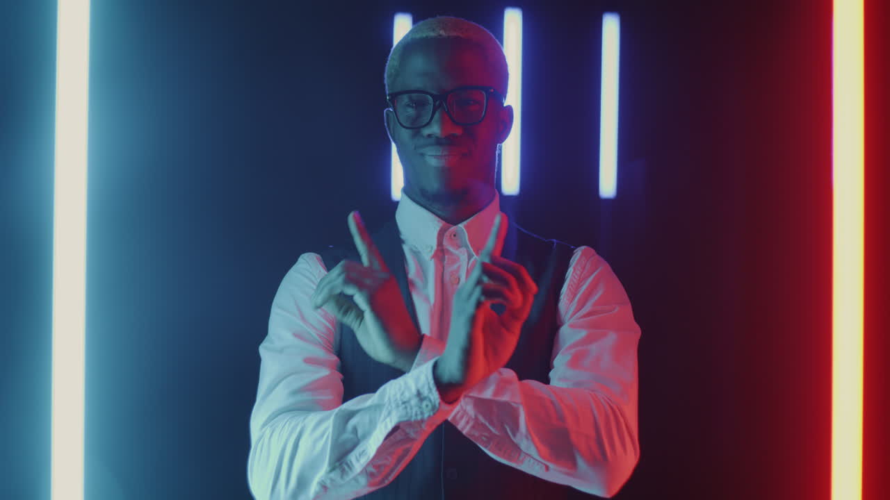Confident Man Posing in Neon Lights