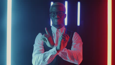 confident man posing in neon lights