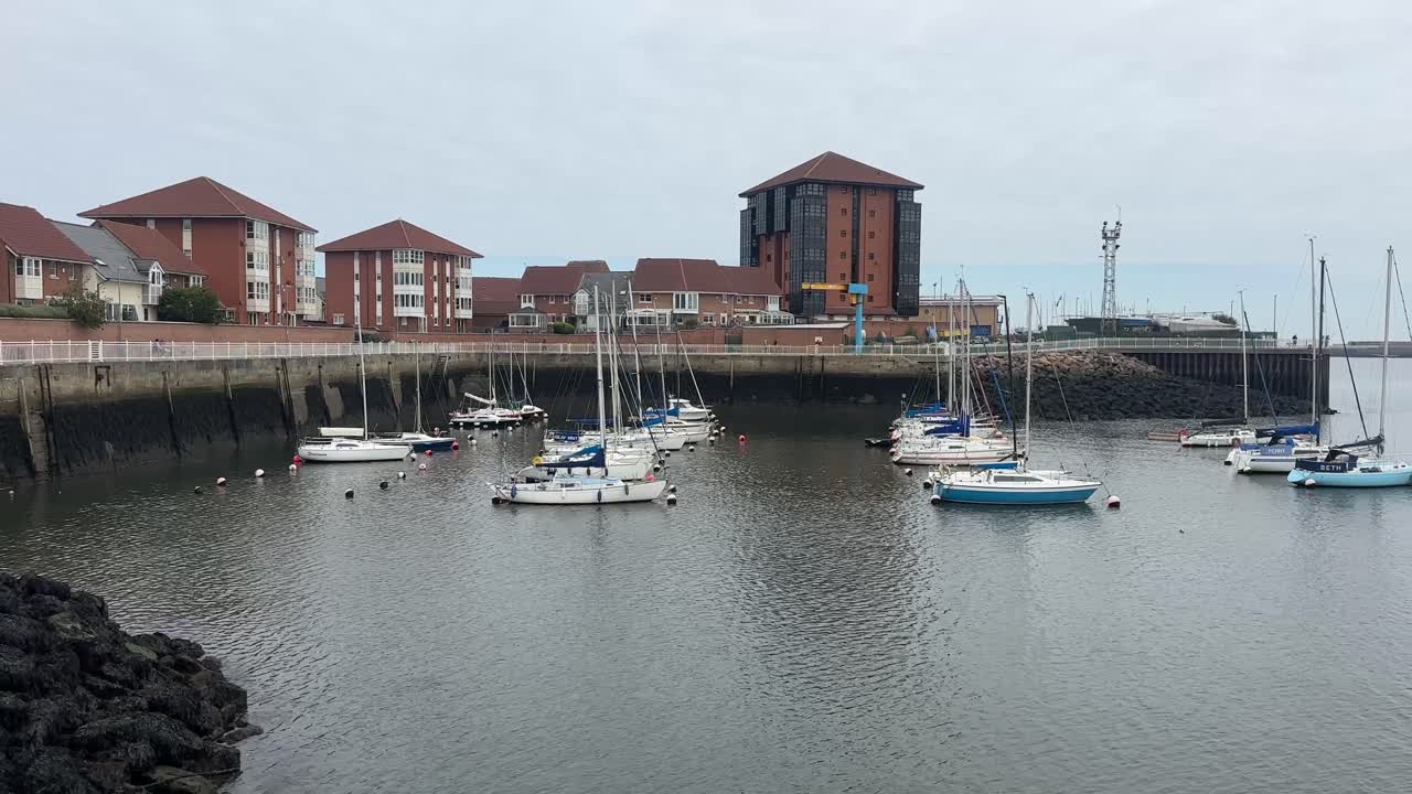 Scenic View of Sunderland Marina with Boats Docked Along Waterfront and Calm Water Reflections