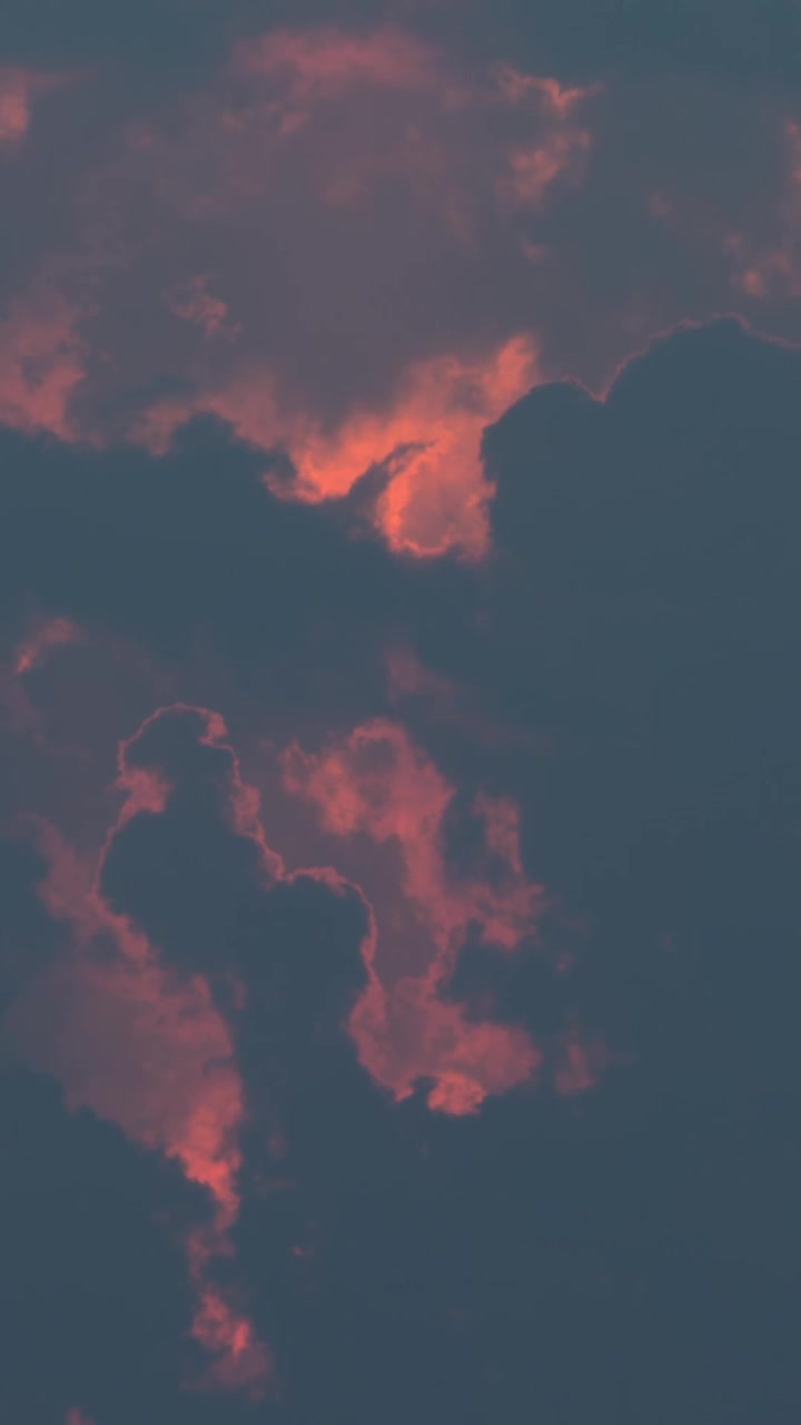 Evening sky view. Clouds with red tint