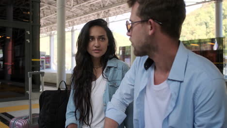 couple talking at a train station