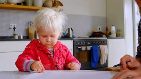 father helping his daughter drawing at home 4k