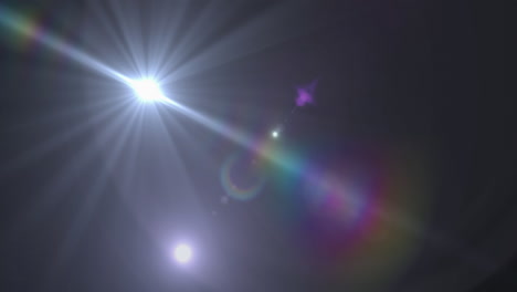 mancha de luz y destello de la lente contra un fondo negro