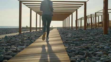 woman running on a beach path