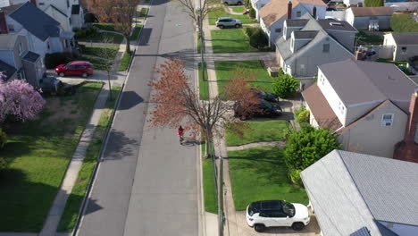 an aerial shot over a suburban neighborhood on a sunny day