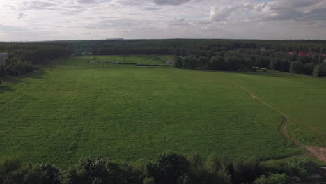 flying over green field and rural road near the village russia