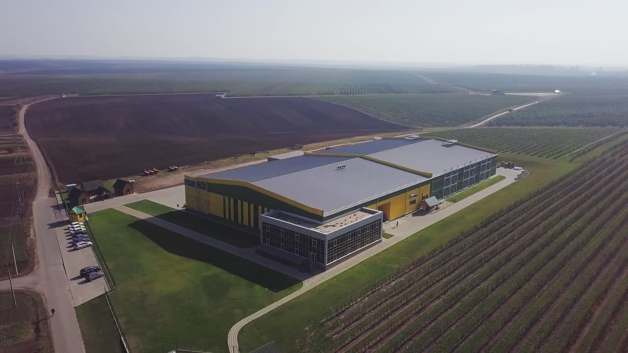 Aerial over fruit orchard farm showing different buildings to warehouse apples and pears also in background showing trees that grow the fresh fruit important food production site healthy food 4k