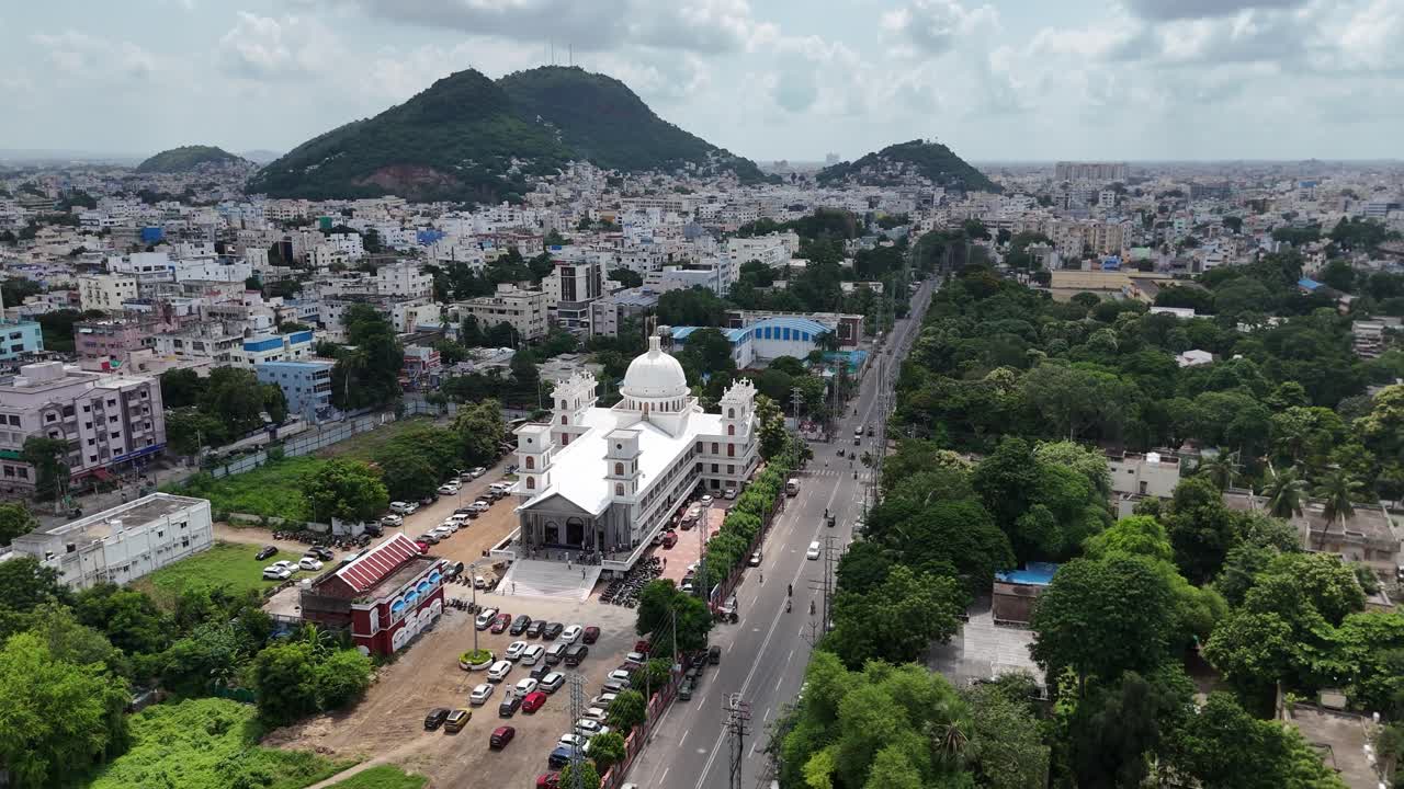 A stunning aerial view of Vijayawada city with a hill in the background, showcasing the blend of urban and natural beauty.