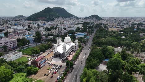 a stunning aerial view of vijayawada city with a hill in the background, showcasing the blend of urban and natural beauty.