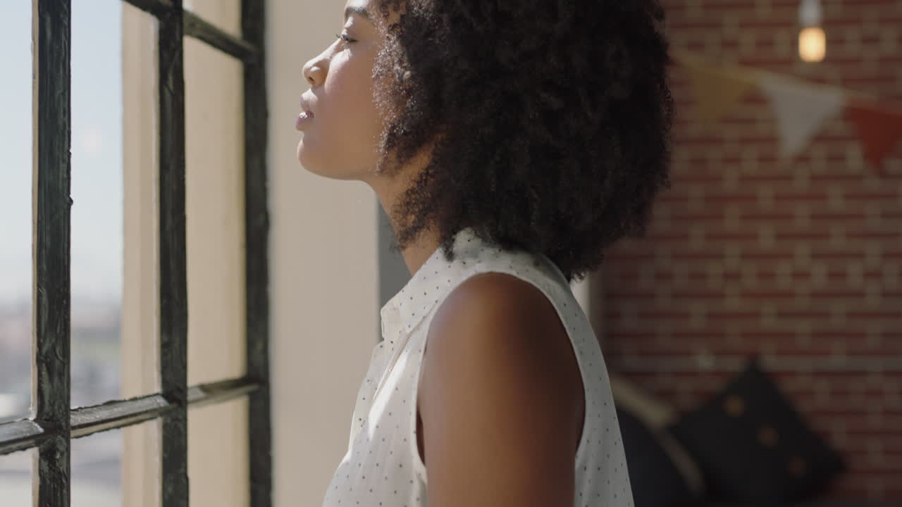 happy young woman using smartphone at home browsing social media messages enjoying relaxed morning looking out window