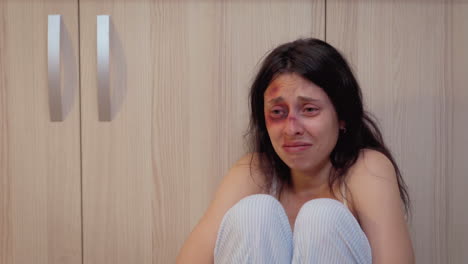 drunk man standing over a crying woman