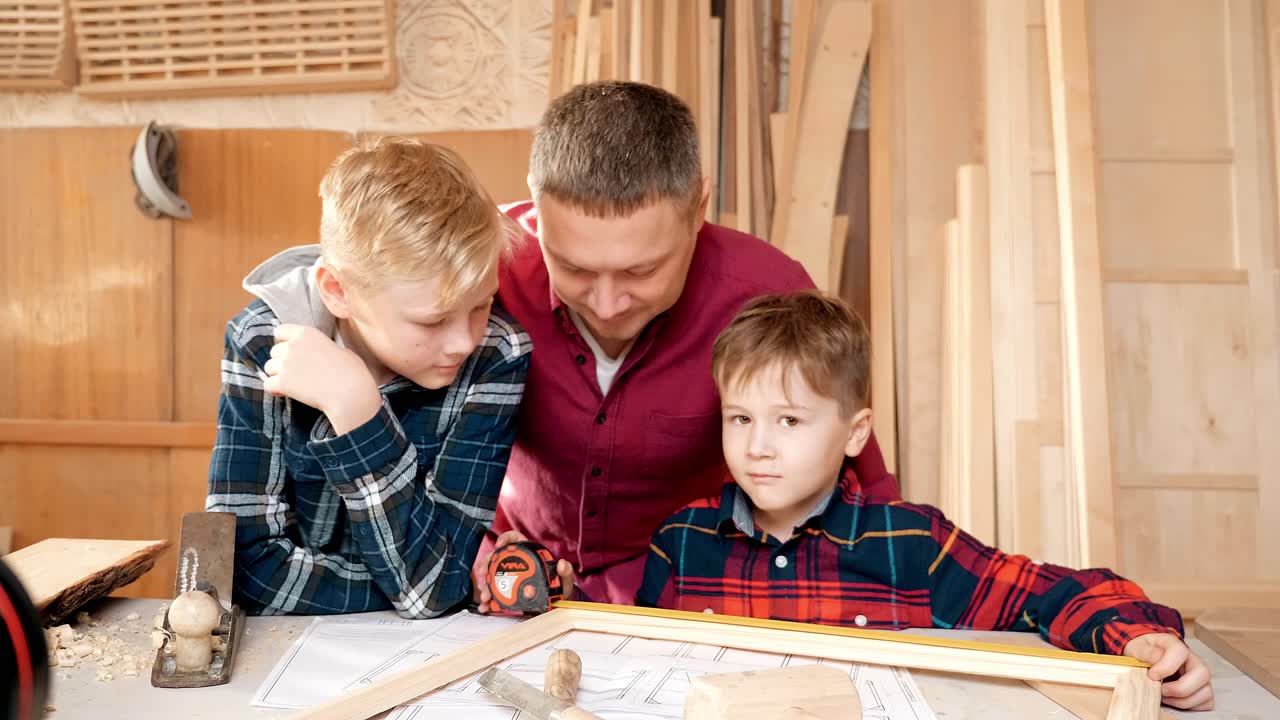 Father and Sons Working in a Workshop