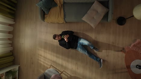 man lying on the floor in the living room