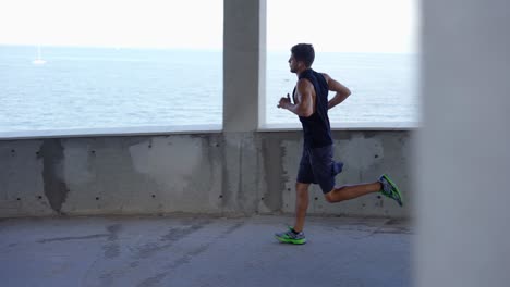 Man-runs-around-by-levels-of-and-empty-parking-garage