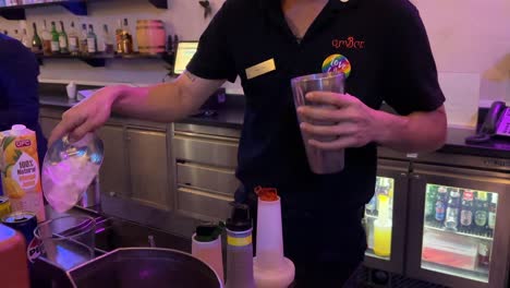 a bartender in a dimly lit bangkok bar swiftly adds ice to a cocktail shaker, preparing a drink with efficient, practiced movements. static camera, warm ambient lighting