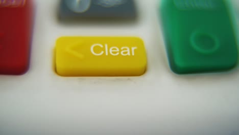 a macro close up shot of a pin pad numbers and letters on colorful buttons, smooth pull up movement, full hd video, super slow motion, blurry depth of field