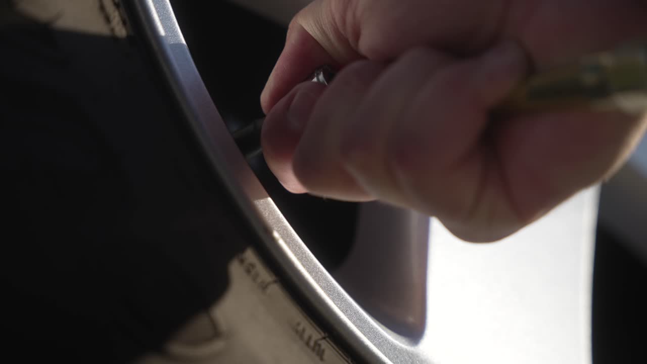 Close-up of inflating an SUV tire with an air hose attachment