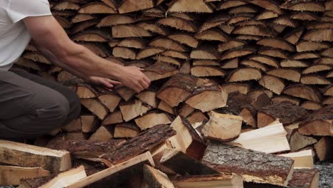 man is arranging cut lumber into stacked