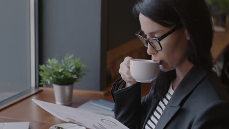 businesswoman reviewing data in a cafe