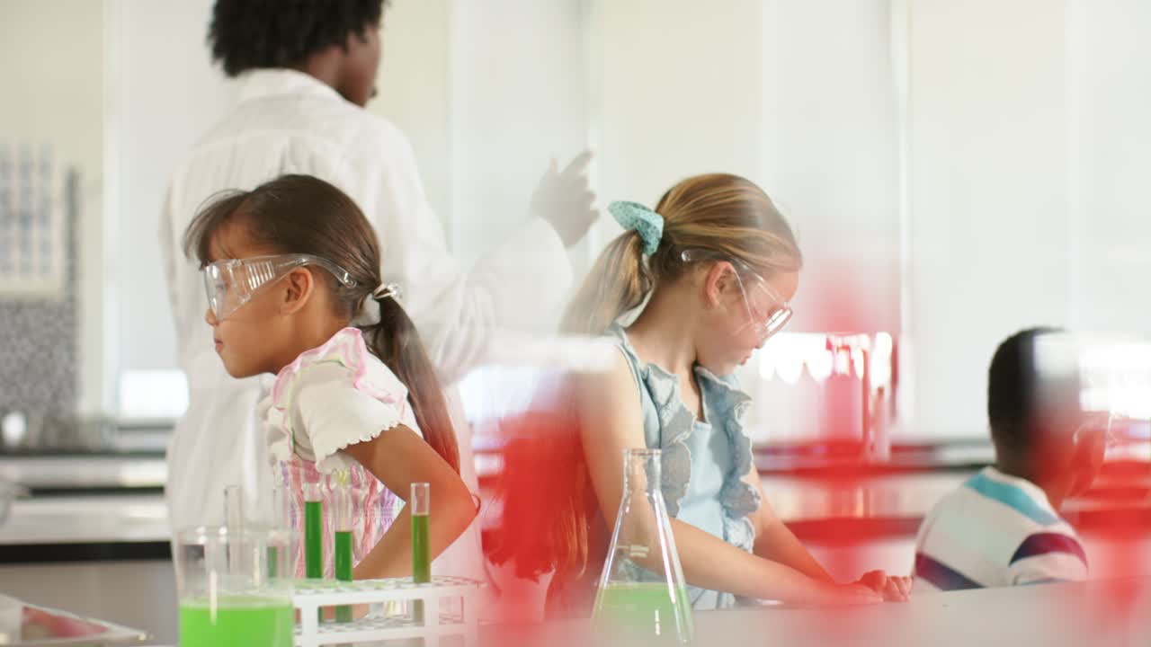 School pupils fixing goggles, using test tubes, flask as teacher in lab coat gesturing at bench