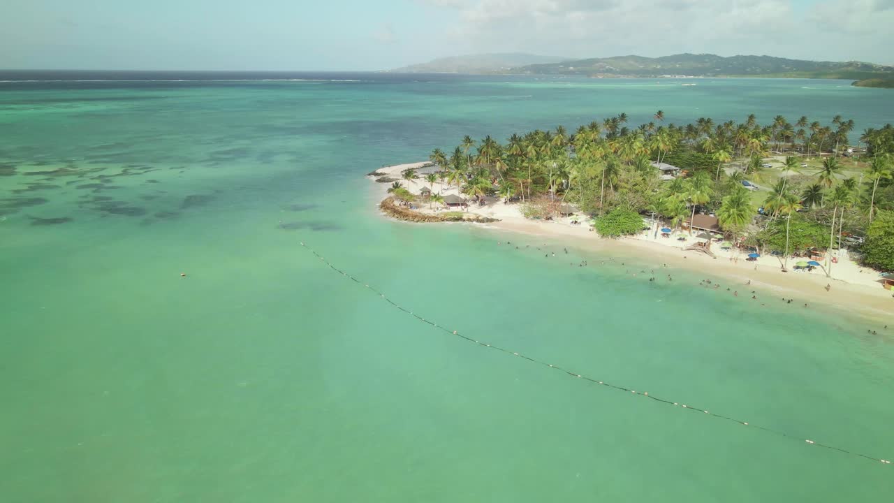 A stunning aerial image of Tobago's soft white sands and crystal-clear coastline in the Caribbean.