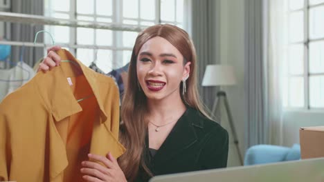 young asian transgender woman selling clothes online by live streaming. selling it online live streaming concept