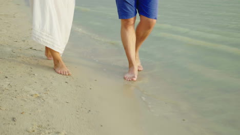 Bare-Feet-Of-A-Man-And-A-Woman-Walk-Along-The-Sand-Along-The-Sea-Holiday-Together-In-The-Tropics-4k-