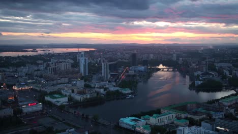 sunset over a city skyline with a river