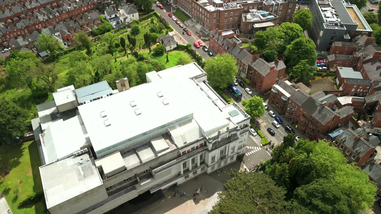 Reversing overhead aerial video of Ulster Museum in Botanic Gardens in Belfast, Northern Ireland on a bright sunny day. Produced in 4K, 60 frames per second and with Rec709 color.