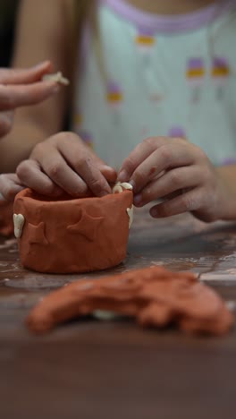 kids making clay pottery