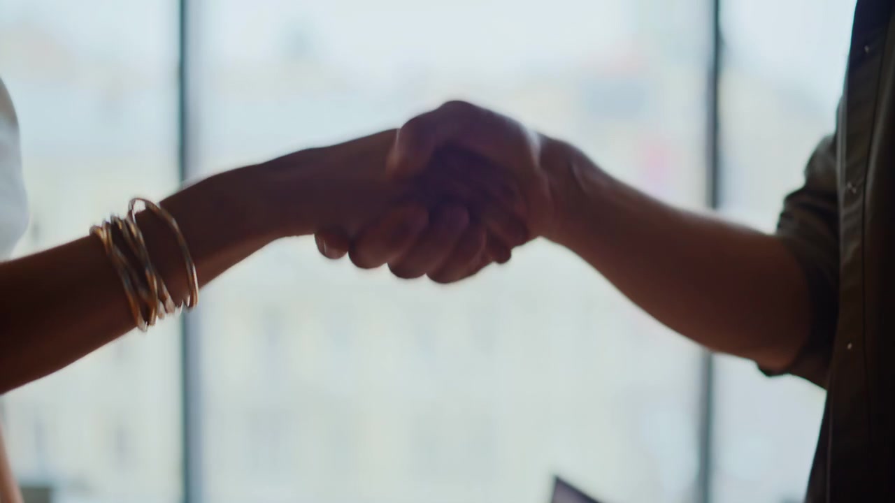 Closeup hands shaking business meeting deal. Partners handshake office agreement