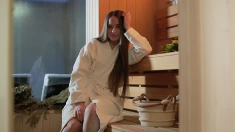 young woman having rest in sauna alone