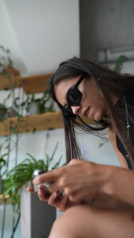 woman using phone in cafe