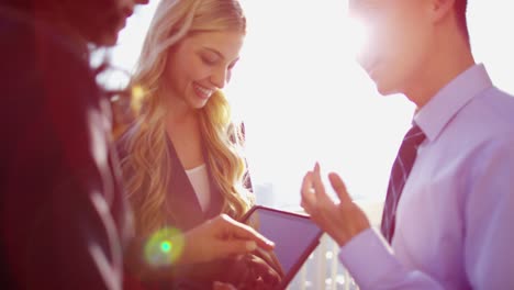 multi ethnic business managers using tablet on rooftop